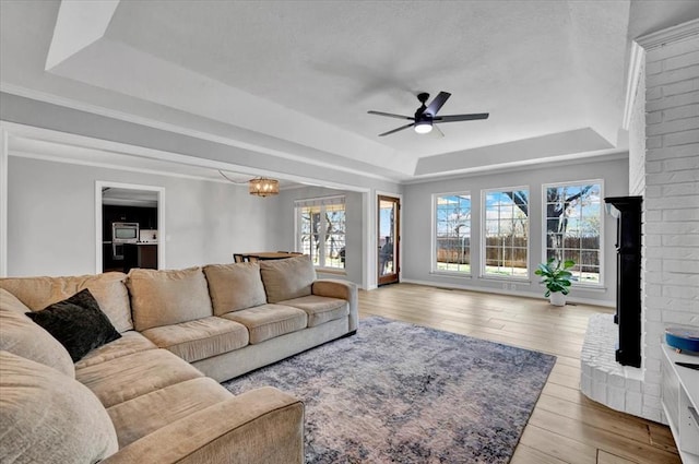 2008 Powderhorn, Edmond, OK 73034 - living area with hardwood / wood-style floors, baseboards, a tray ceiling, crown molding, and ceiling fan with notable chandelier