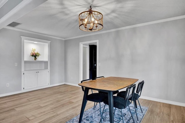 2008 Powderhorn, Edmond, OK 73034 - dining area with a notable chandelier, light wood-style floors, visible vents, and baseboards