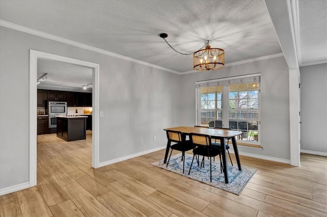 2008 Powderhorn, Edmond, OK 73034 - dining space with a chandelier, light wood-style flooring, and baseboards