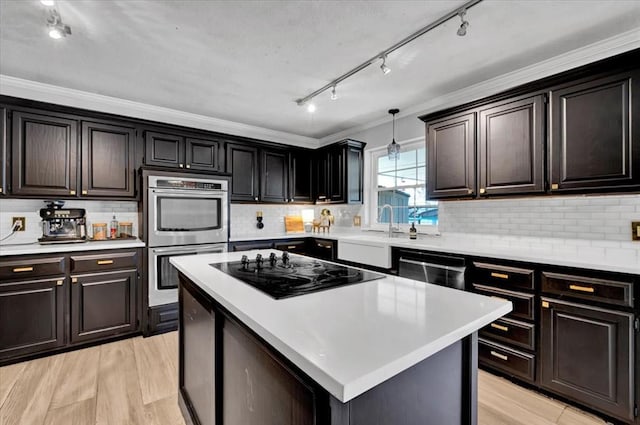 2008 Powderhorn, Edmond, OK 73034 - kitchen with light wood-style floors, stainless steel double oven, light countertops, and black electric cooktop