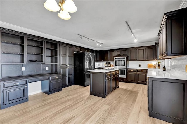 2008 Powderhorn, Edmond, OK 73034 - kitchen featuring light wood finished floors, a kitchen island, stainless steel double oven, light countertops, and refrigerator with ice dispenser