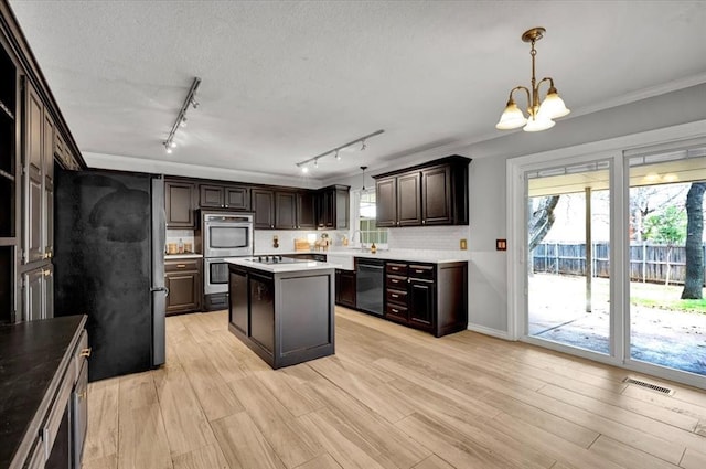 2008 Powderhorn, Edmond, OK 73034 - kitchen featuring an inviting chandelier, crown molding, a wealth of natural light, and stainless steel appliances