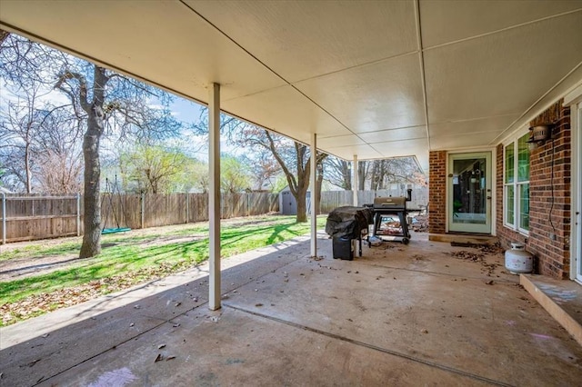 2008 Powderhorn, Edmond, OK 73034 - view of patio with a fenced backyard, a grill, an outdoor structure, and a shed