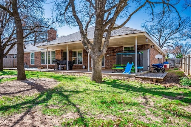 2008 Powderhorn, Edmond, OK 73034 - rear view of property featuring a patio, fence, a yard, brick siding, and a chimney