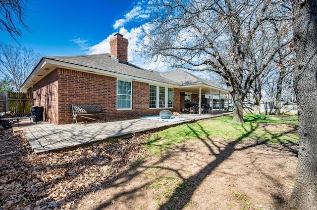 2008 Powderhorn, Edmond, OK 73034 - back of property with brick siding, a chimney, a patio, and fence