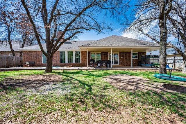 2008 Powderhorn, Edmond, OK 73034 - back of property with a patio area, fence, brick siding, and a lawn