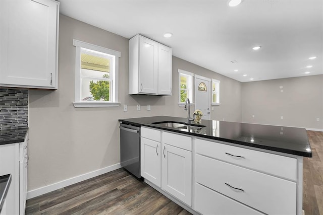 311 N 7th St, Sayre, OK 73662 - kitchen with stainless steel dishwasher, a peninsula, dark wood-style floors, decorative backsplash, and white cabinets