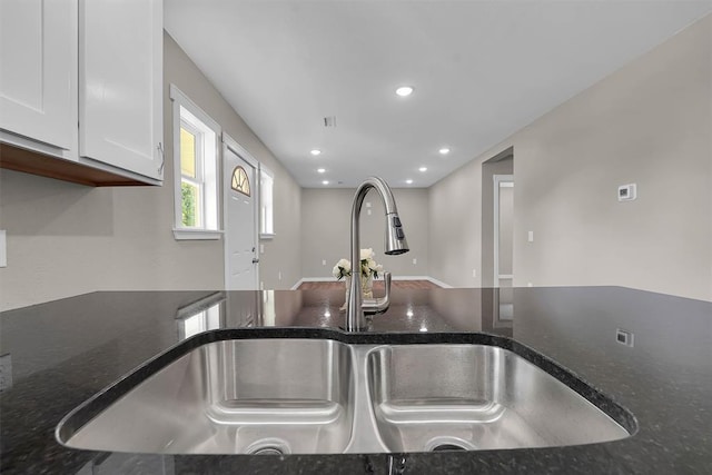 311 N 7th St, Sayre, OK 73662 - kitchen view of white cabinetry, dark stone countertops, and recessed lighting
