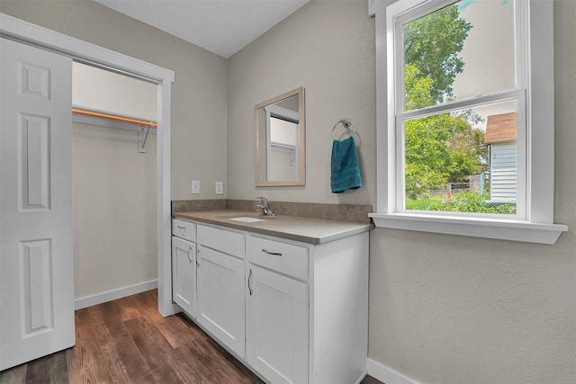 311 N 7th St, Sayre, OK 73662 - bathroom with vanity, plenty of natural light, and wood finished floors