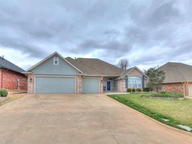 view of front of house featuring brick siding, an attached garage, concrete driveway, and a front yard