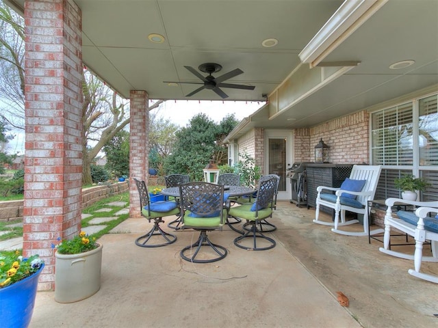view of patio with outdoor dining space and a ceiling fan