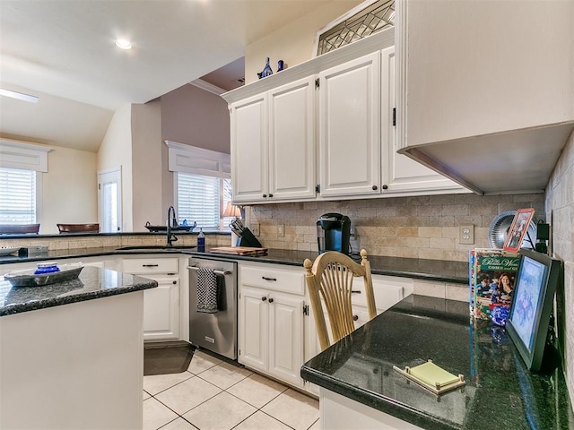 kitchen with a sink, white cabinetry, stainless steel dishwasher, and light tile patterned floors