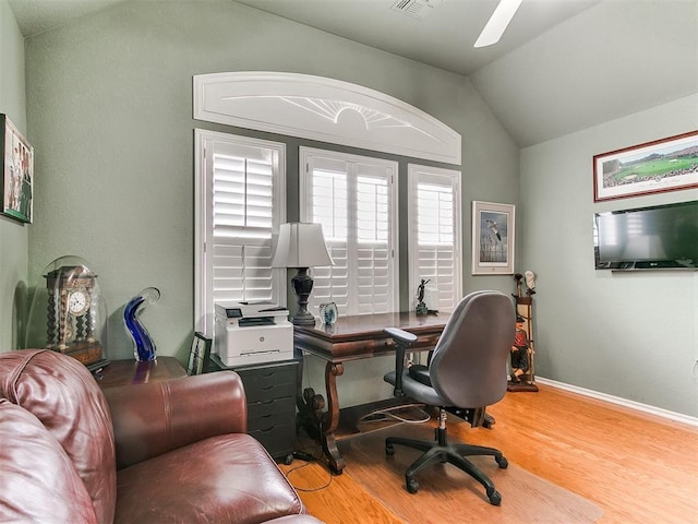 home office with lofted ceiling, wood finished floors, and baseboards