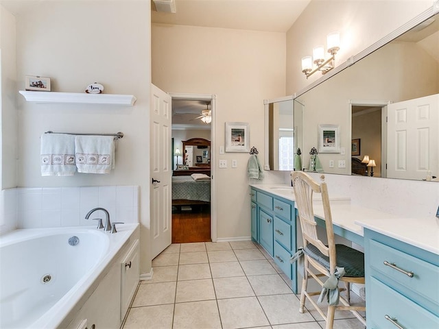 ensuite bathroom with a jetted tub, connected bathroom, tile patterned flooring, ceiling fan, and vanity