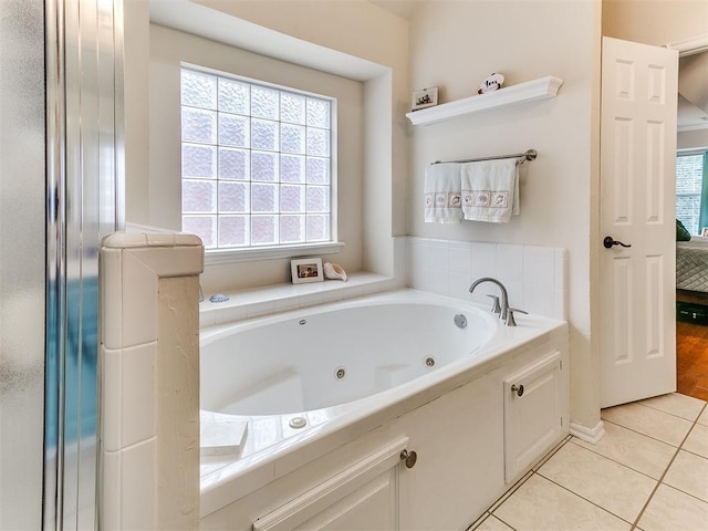 ensuite bathroom with tile patterned floors, a jetted tub, and ensuite bath