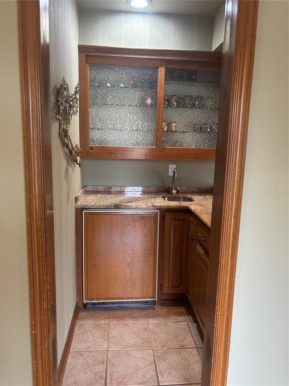 2001 Woodhill Rd, Edmond, OK 73025 - bar featuring indoor wet bar, a sink, and light tile patterned floors