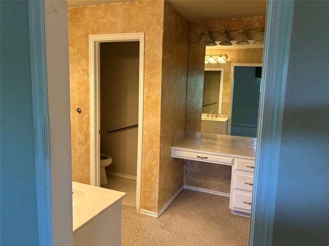 2001 Woodhill Rd, Edmond, OK 73025 - bathroom featuring vanity, baseboards, and toilet