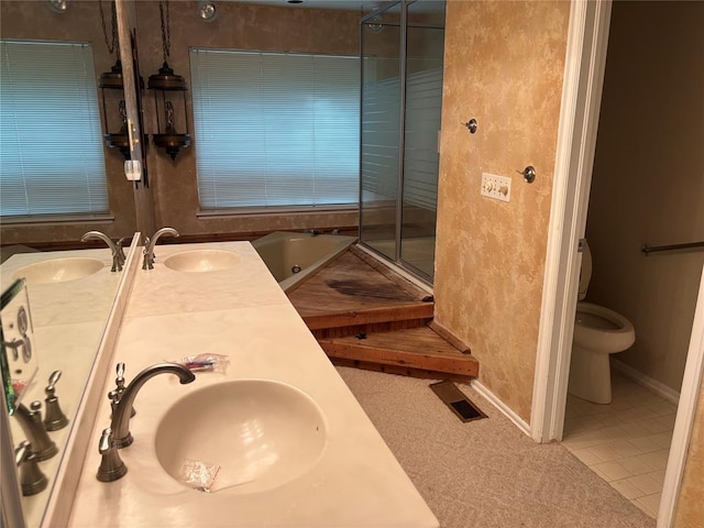 2001 Woodhill Rd, Edmond, OK 73025 - full bath with a sink, double vanity, toilet, baseboards, and a stall shower