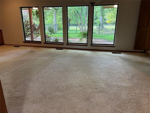 2001 Woodhill Rd, Edmond, OK 73025 - unfurnished room featuring baseboards, carpet flooring, and visible vents