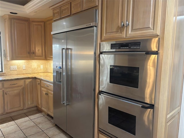 2001 Woodhill Rd, Edmond, OK 73025 - kitchen with backsplash, crown molding, appliances with stainless steel finishes, light stone countertops, and light tile patterned floors
