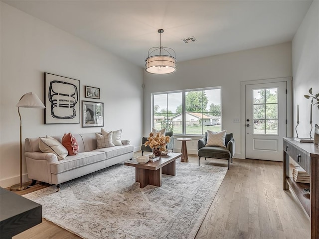 living room featuring light wood-type flooring and visible vents