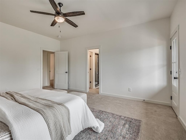 bedroom with light colored carpet, baseboards, and a ceiling fan