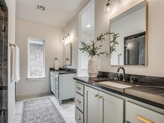 full bathroom featuring visible vents, marble finish floor, two vanities, and a sink