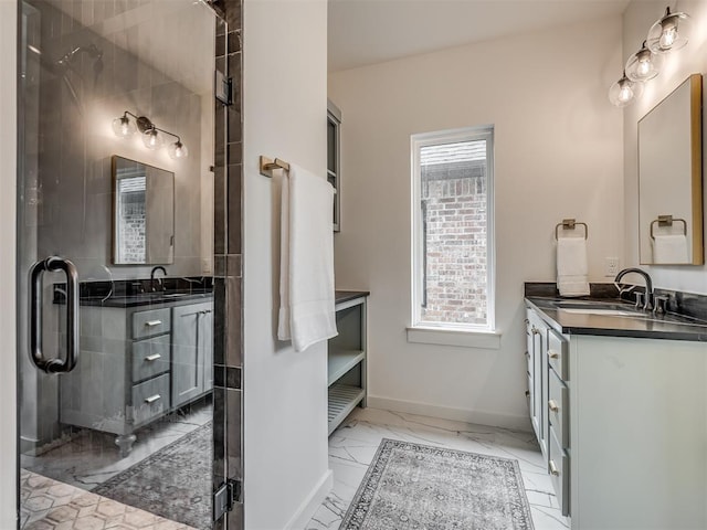 bathroom with baseboards, marble finish floor, a shower with shower door, and vanity