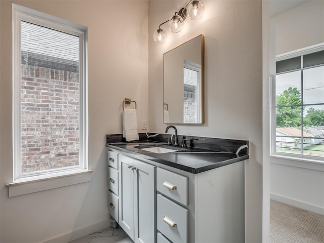bathroom with baseboards and vanity