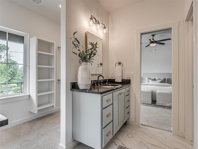 ensuite bathroom with a ceiling fan, visible vents, baseboards, marble finish floor, and vanity
