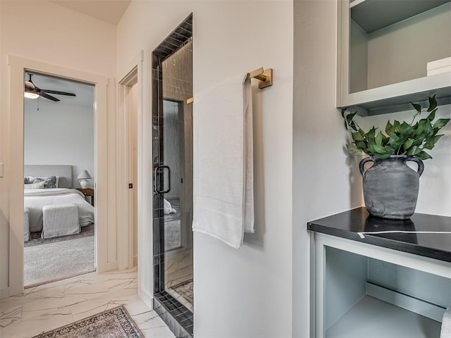 bathroom with ensuite bath, a ceiling fan, marble finish floor, and a shower stall