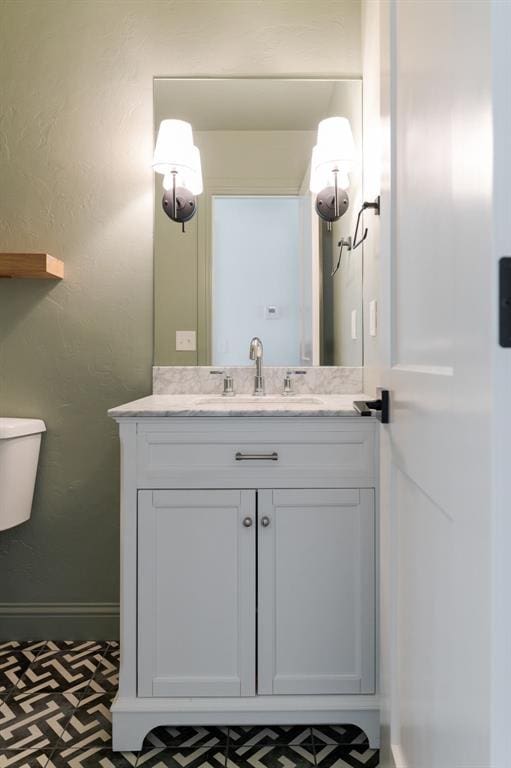 10912 Willow Grove Rd, Oklahoma City, OK 73120 - bathroom with toilet, vanity, and baseboards