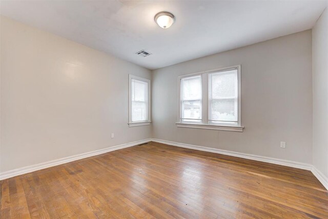 2929 NW 12th St, Oklahoma City, OK 73107 - unfurnished room featuring visible vents, baseboards, and hardwood / wood-style flooring