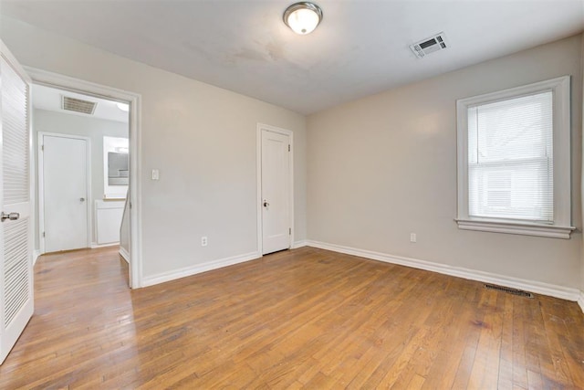 2929 NW 12th St, Oklahoma City, OK 73107 - empty room featuring visible vents, baseboards, and light wood-style flooring
