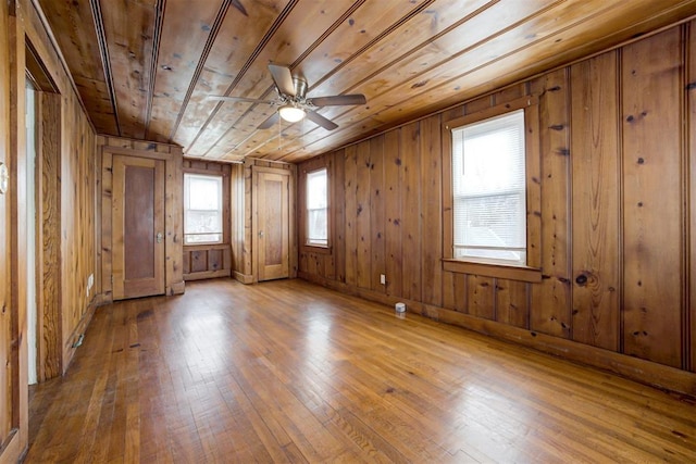2929 NW 12th St, Oklahoma City, OK 73107 - spare room with ceiling fan, wooden walls, wooden ceiling, and hardwood / wood-style flooring