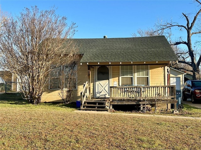 2929 NW 12th St, Oklahoma City, OK 73107 - view of front of home with roof with shingles, a porch, and a front yard
