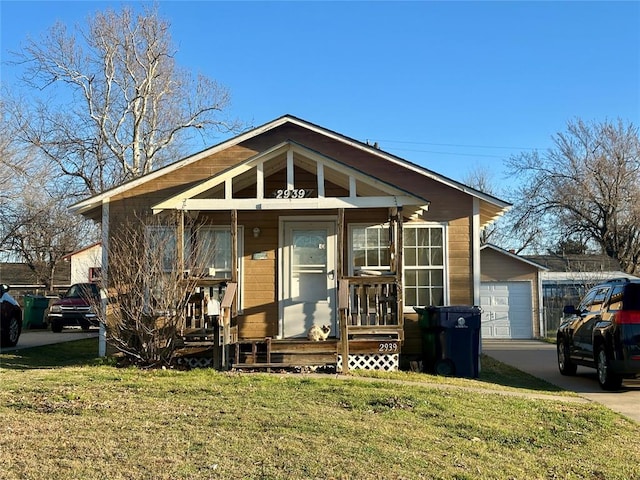 2929 NW 12th St, Oklahoma City, OK 73107 - bungalow with a garage, driveway, a porch, and a front lawn