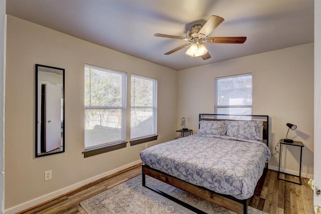 2929 NW 12th St, Oklahoma City, OK 73107 - bedroom with a ceiling fan, baseboards, and wood finished floors