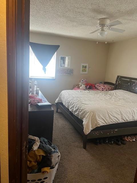 4912 Cinderella Dr, Oklahoma City, OK 73129 - carpeted bedroom featuring a textured ceiling and a ceiling fan