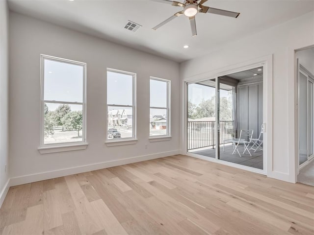 8 S Howard St, Edmond, OK 73003 - unfurnished room with baseboards, light wood-type flooring, a wealth of natural light, and ceiling fan