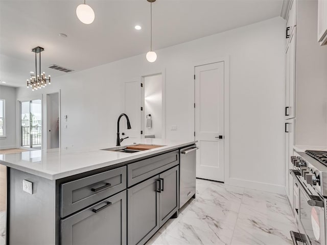 8 S Howard St, Edmond, OK 73003 - kitchen with visible vents, marble finish floor, gray cabinetry, a sink, and stainless steel appliances