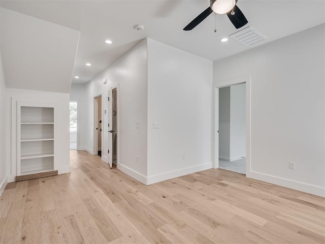 8 S Howard St, Edmond, OK 73003 - unfurnished room featuring built in features, baseboards, visible vents, light wood-style flooring, and recessed lighting