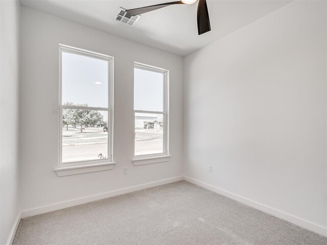 8 S Howard St, Edmond, OK 73003 - empty room with ceiling fan, baseboards, visible vents, and light carpet
