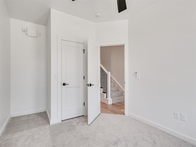 8 S Howard St, Edmond, OK 73003 - unfurnished bedroom with baseboards, carpet, and a ceiling fan