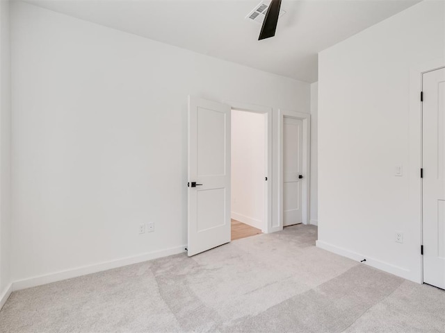 8 S Howard St, Edmond, OK 73003 - unfurnished bedroom with baseboards, visible vents, and light carpet