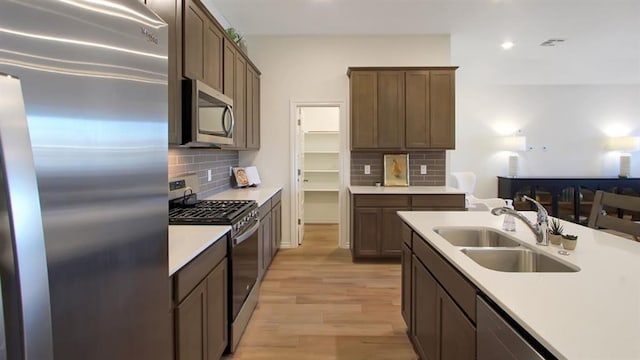 5412 Windstone Ln, Norman, OK 73072 - kitchen featuring stainless steel appliances, recessed lighting, light countertops, and light wood-type flooring
