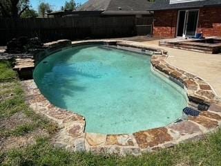 view of swimming pool featuring fence, a patio area, and a fenced in pool