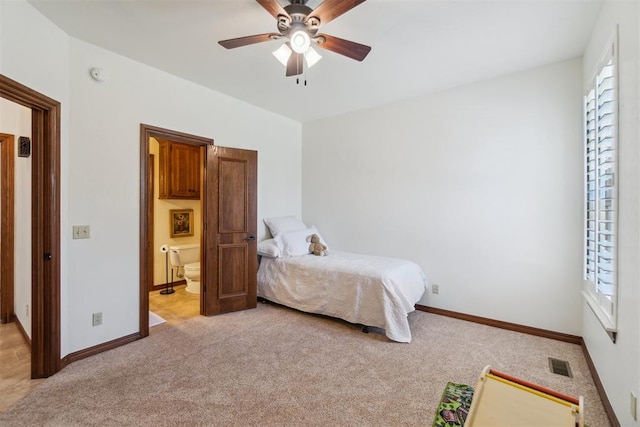 1216 Camelot Dr, Yukon, OK 73099 - bedroom featuring light carpet, baseboards, connected bathroom, and a ceiling fan