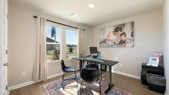 office space with visible vents, baseboards, and wood finished floors