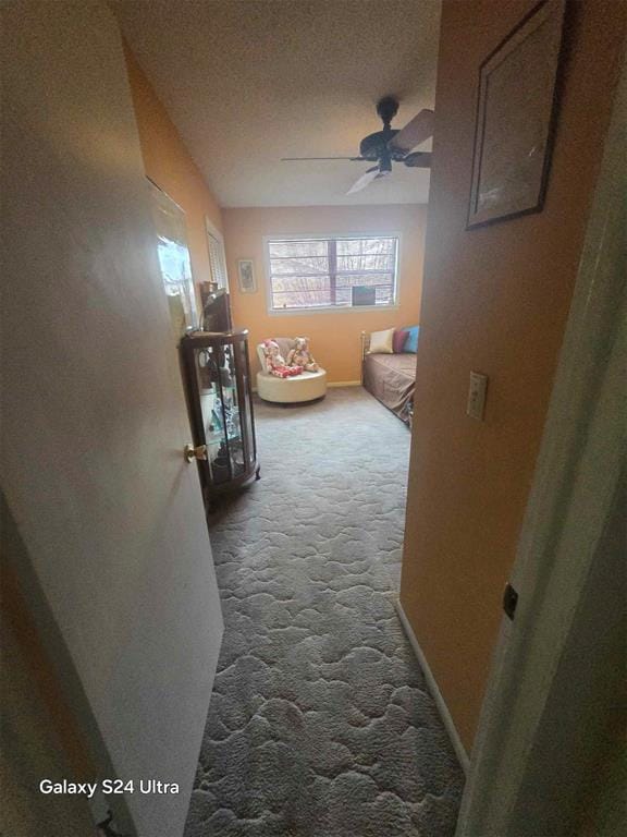 506 E Oklahoma St, Walters, OK 73572 - hallway featuring a textured ceiling, baseboards, and dark carpet
